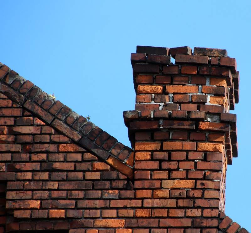 Damaged chimney on an Hurst home showing cracks and missing mortar